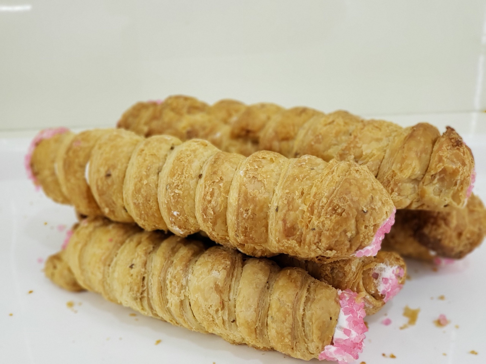 Crispy cream rolls filled with pink cream