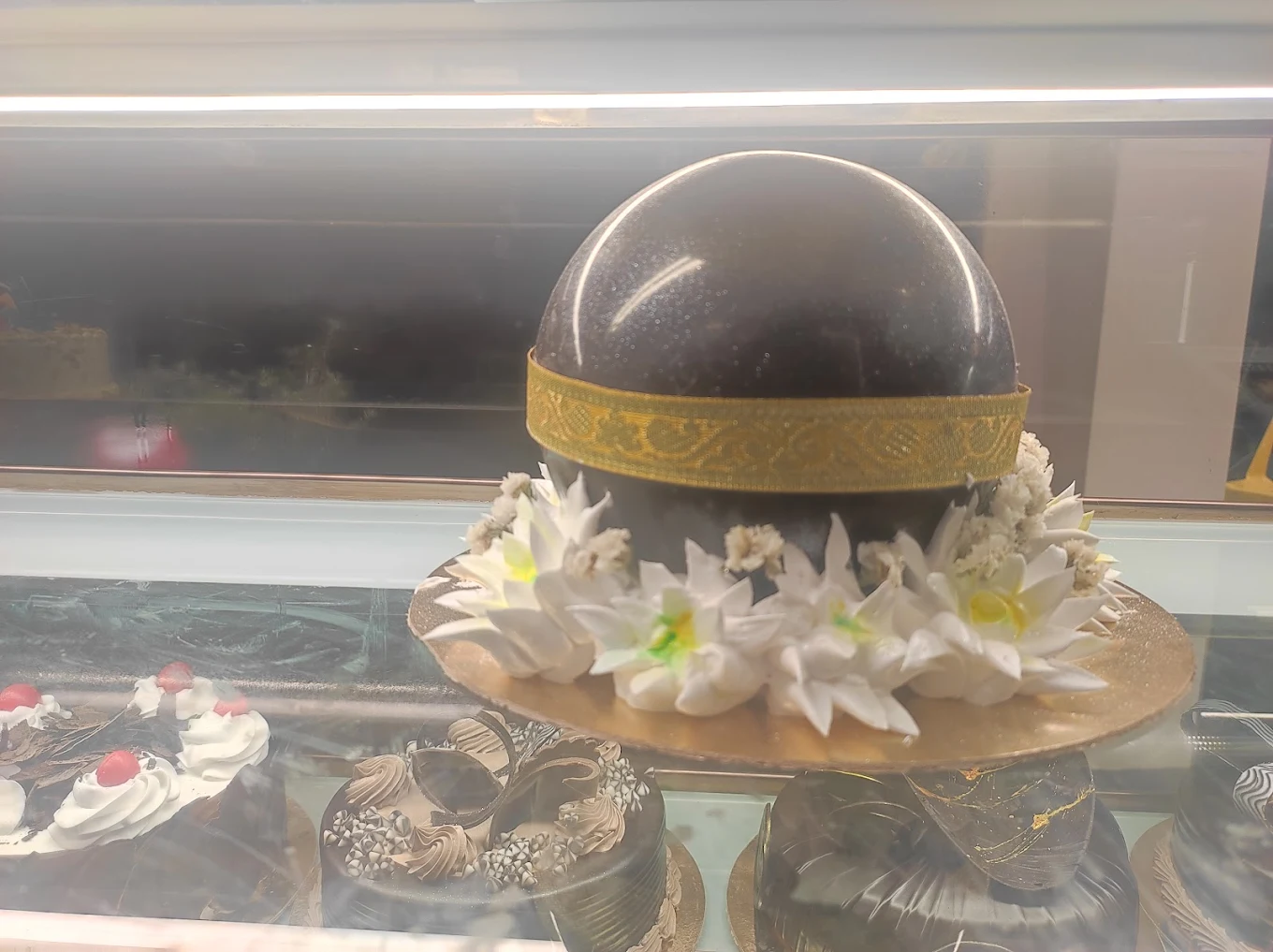 Dome-shaped chocolate masterpiece cake with gold band