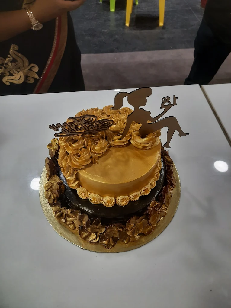 Two-tier golden chocolate celebration cake