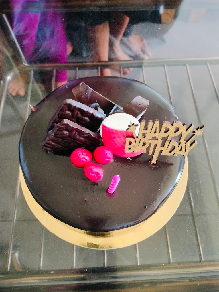 Glossy chocolate ganache birthday cake with pink accents