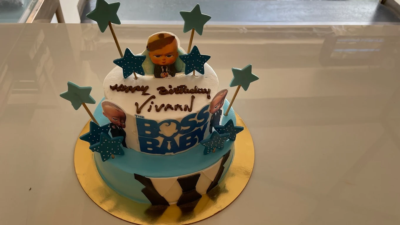 Boss Baby themed birthday cake with star toppers