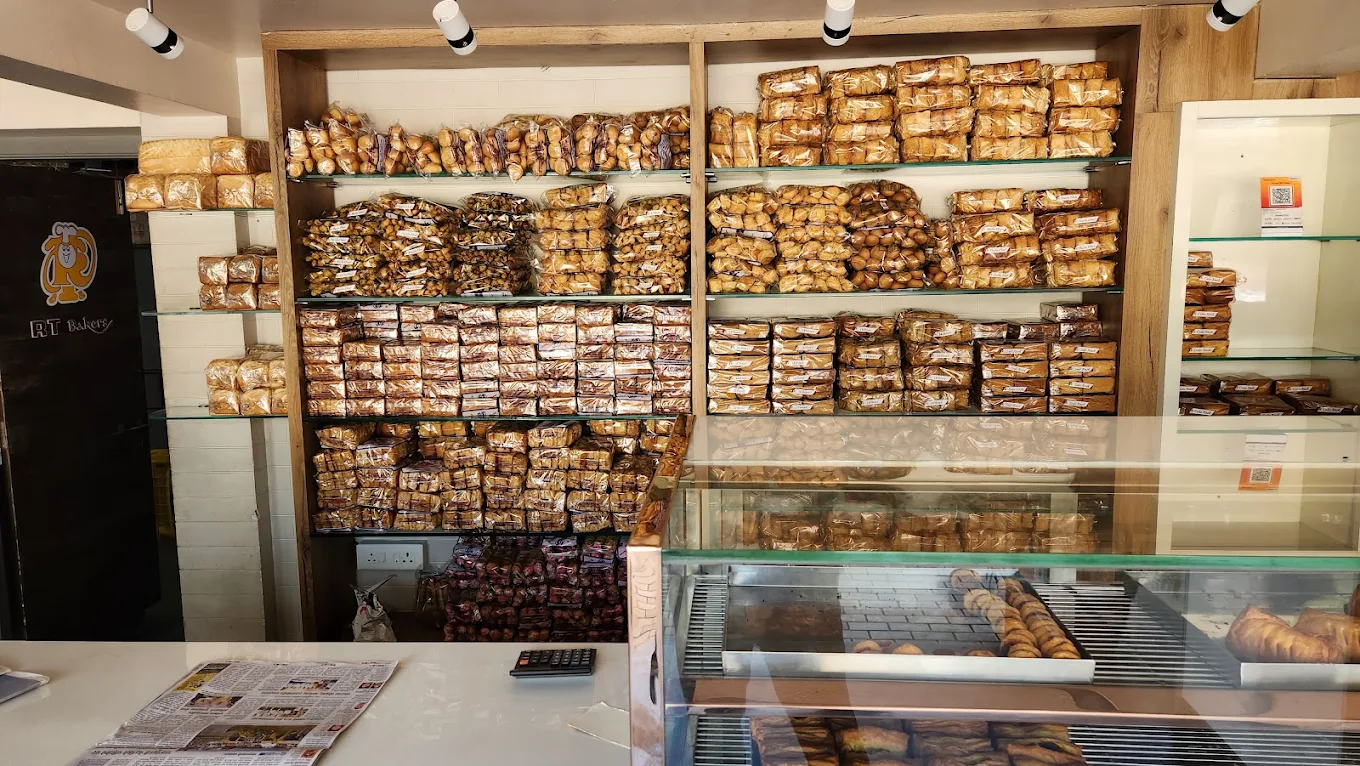 Shelves stacked with fresh toasts and bread at RT Bakers